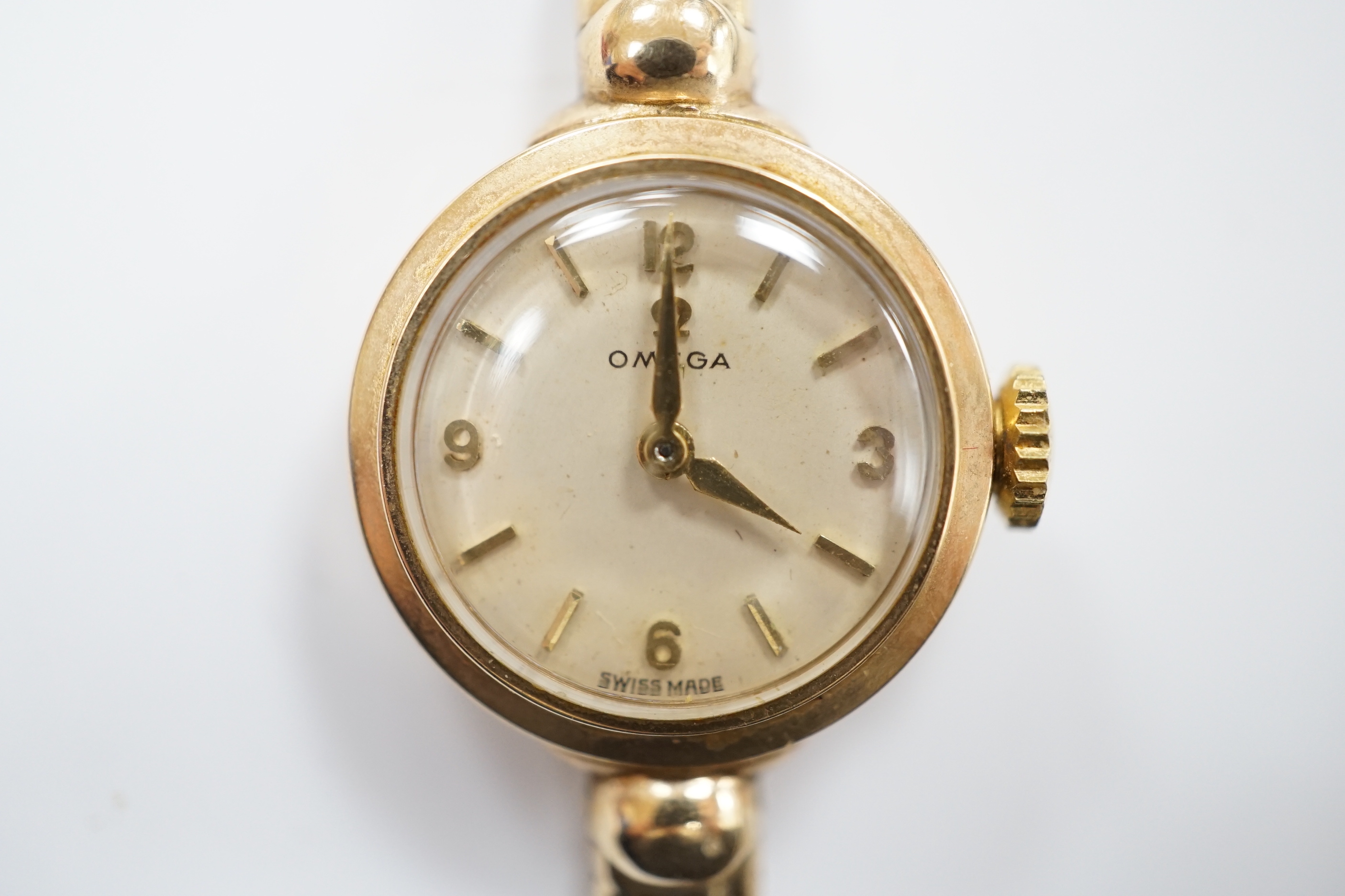 A lady's 9ct gold Omega manual wind wrist watch, on an associated 9ct gold bracelet, gross weight 17.6 grams, with Omega box.
